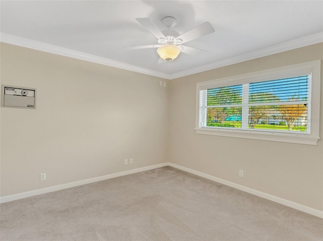 empty room featuring light carpet, crown molding, and ceiling fan