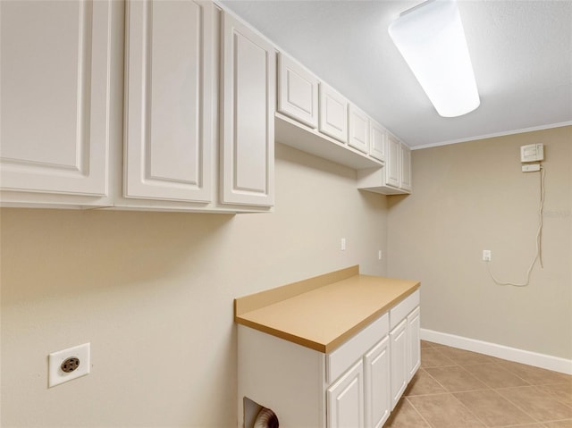 washroom with crown molding, light tile patterned flooring, cabinets, and hookup for an electric dryer