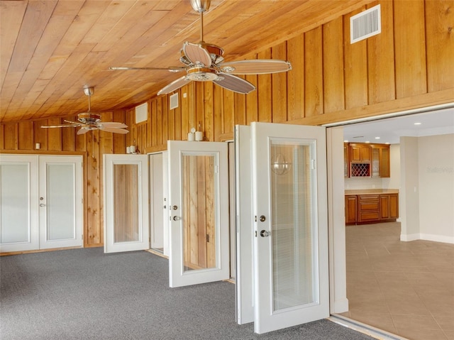 interior space featuring light tile patterned floors, vaulted ceiling, french doors, and wooden ceiling