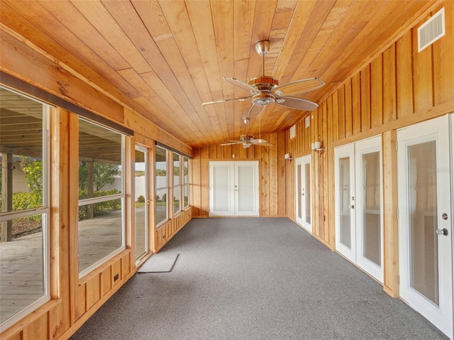 unfurnished sunroom featuring ceiling fan, french doors, wooden ceiling, and lofted ceiling