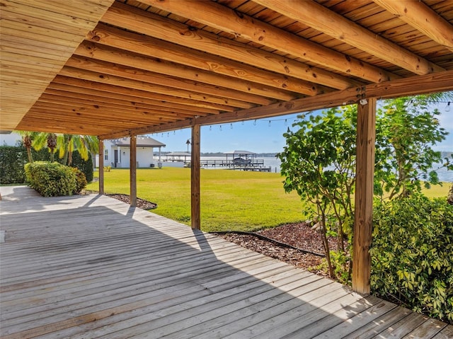 wooden terrace featuring a yard and a water view