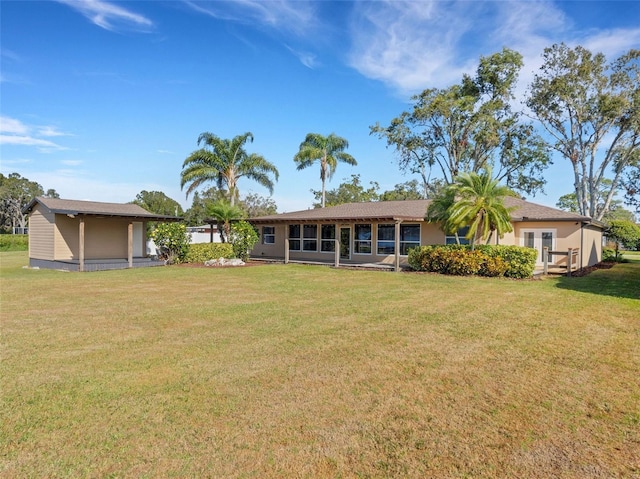 rear view of property featuring a yard