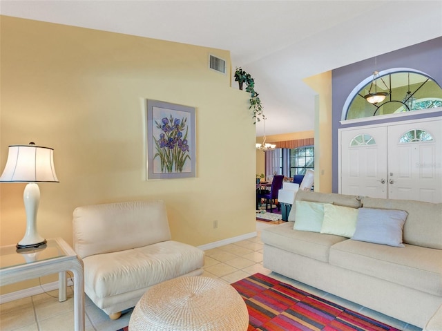 tiled living room featuring vaulted ceiling and a chandelier