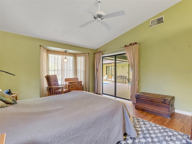 bedroom featuring ceiling fan, access to exterior, light hardwood / wood-style flooring, and vaulted ceiling