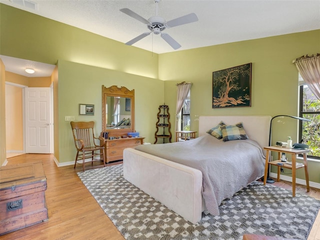 bedroom with light hardwood / wood-style flooring and ceiling fan