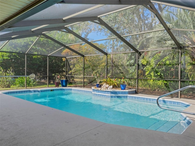 view of swimming pool featuring a lanai