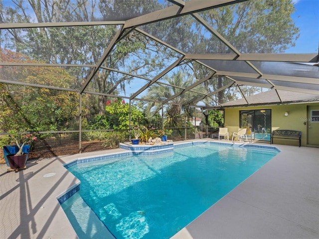 view of swimming pool with a patio and glass enclosure