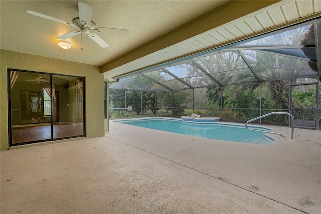 outdoor pool featuring a patio area, glass enclosure, and a ceiling fan