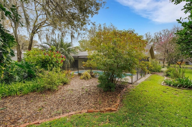 view of yard featuring a lanai and an outdoor pool