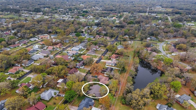 birds eye view of property with a water view and a residential view