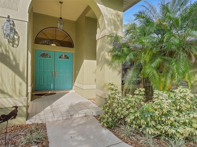 doorway to property featuring stucco siding