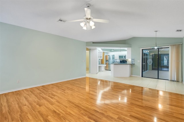 unfurnished living room with light wood-type flooring, ceiling fan, visible vents, and lofted ceiling