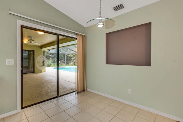 unfurnished room featuring a sunroom, baseboards, light tile patterned floors, and visible vents