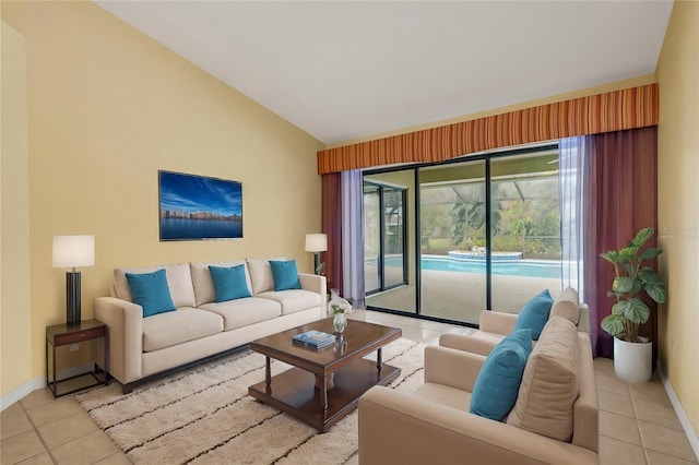 living area featuring lofted ceiling, baseboards, and light tile patterned flooring