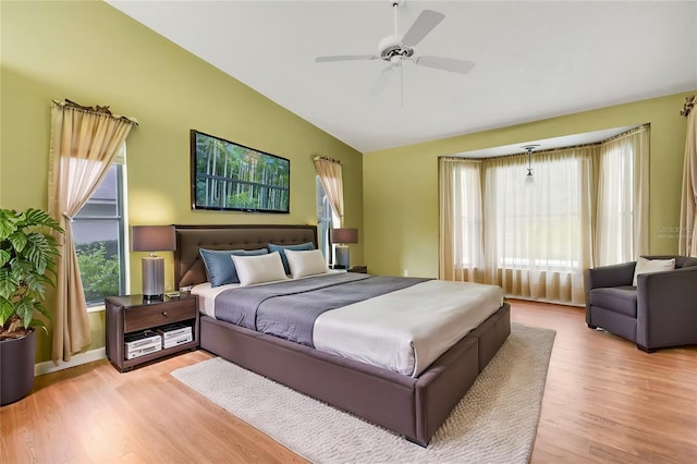 bedroom with light wood-type flooring, lofted ceiling, and ceiling fan