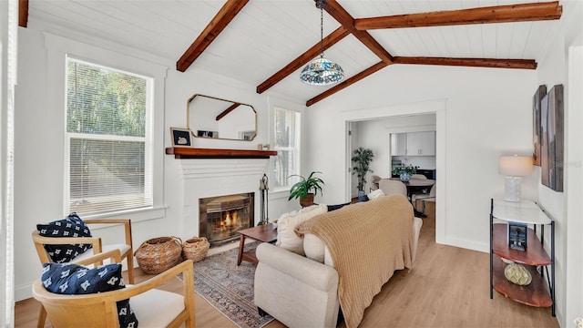 living room featuring vaulted ceiling with beams, light wood-type flooring, and wood ceiling