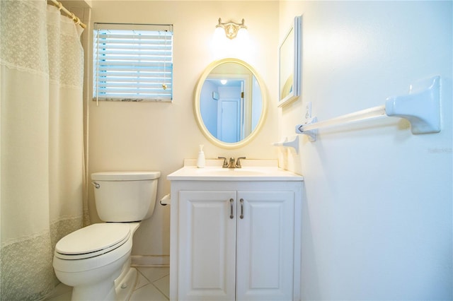 bathroom featuring tile patterned floors, baseboards, toilet, and vanity