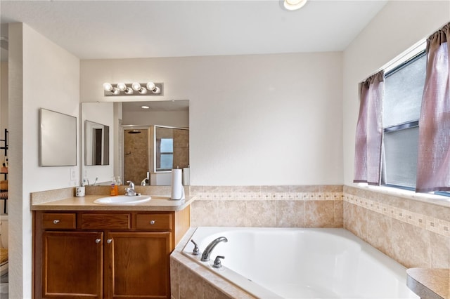 full bathroom with shower with separate bathtub, vanity, toilet, and a wealth of natural light