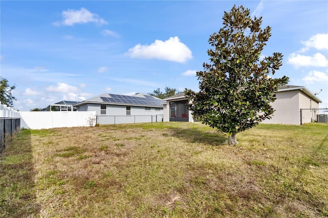 rear view of house with a yard and cooling unit