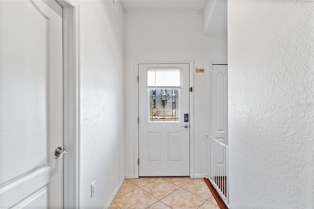 doorway with light tile patterned floors