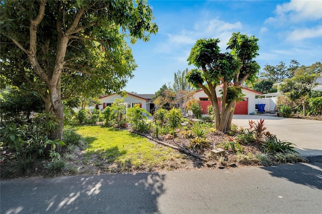 view of front of home with a garage and a front lawn