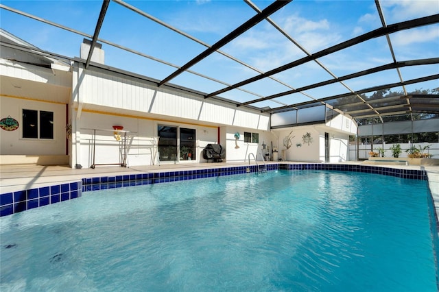 view of swimming pool with a patio and glass enclosure