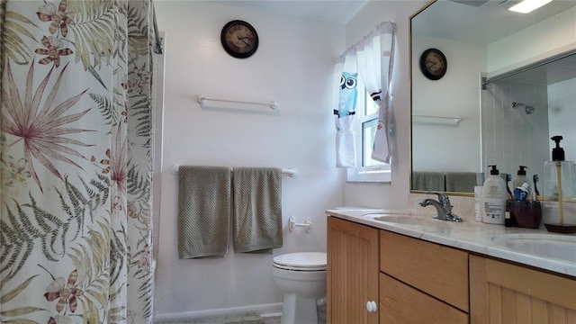 bathroom featuring toilet, double vanity, a sink, and a shower with shower curtain