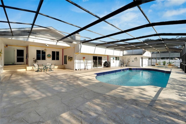 outdoor pool with a patio and a lanai