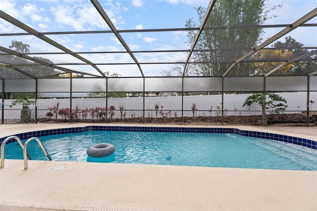 view of swimming pool featuring a fenced in pool, glass enclosure, and a patio