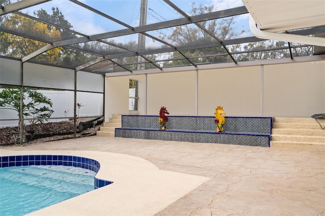 outdoor pool with a lanai and a patio area