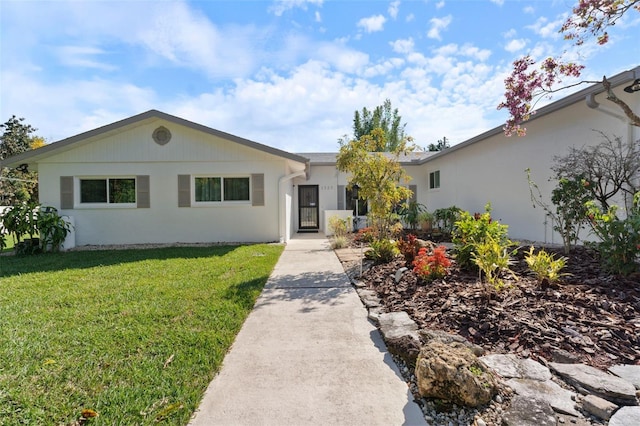 ranch-style home with a front lawn