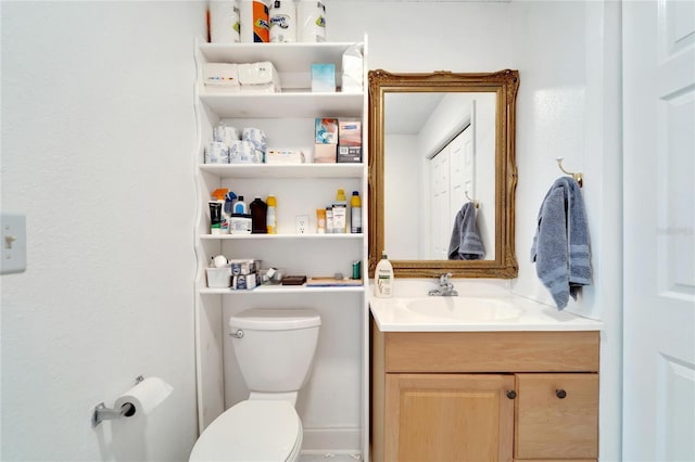 half bathroom featuring toilet and vanity