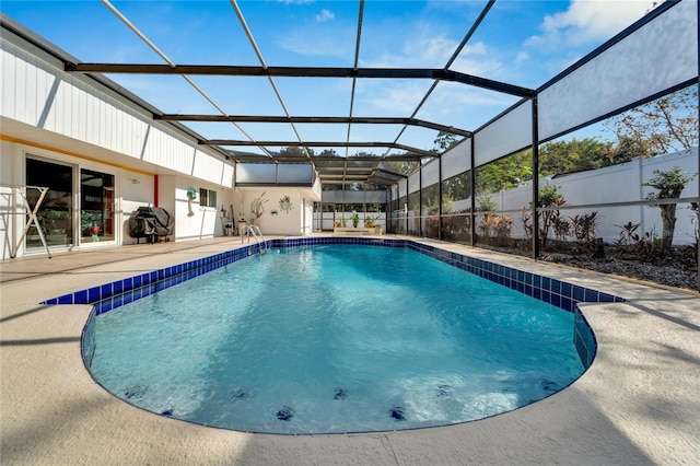 view of swimming pool with glass enclosure, fence, a fenced in pool, and a patio