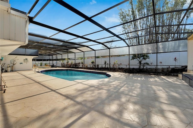 view of pool featuring a patio area, glass enclosure, and a fenced in pool