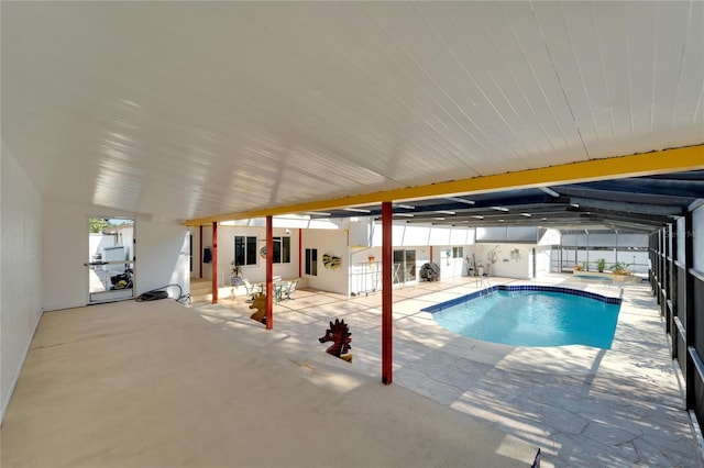 pool with a patio area and fence