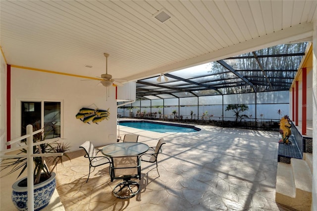 outdoor pool featuring a lanai, a ceiling fan, and a patio