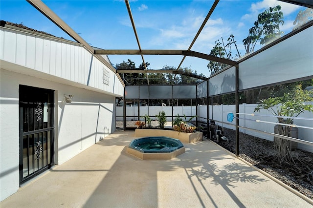 view of patio with a fenced backyard, an outdoor hot tub, and a lanai