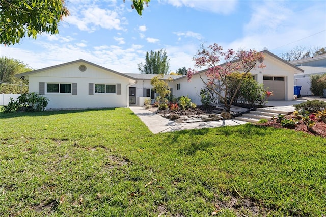 single story home featuring an attached garage and a front yard