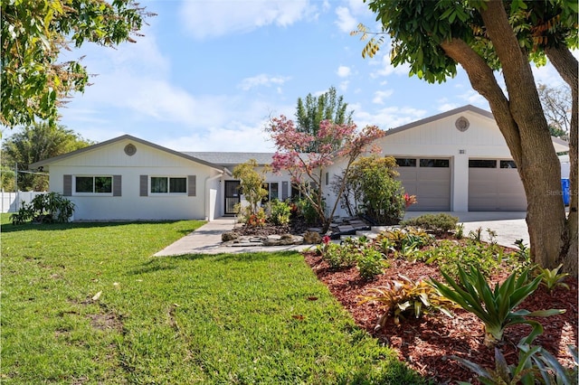 ranch-style home with driveway, an attached garage, and a front yard