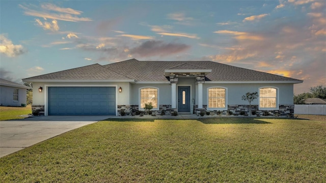 view of front of home featuring a lawn and a garage