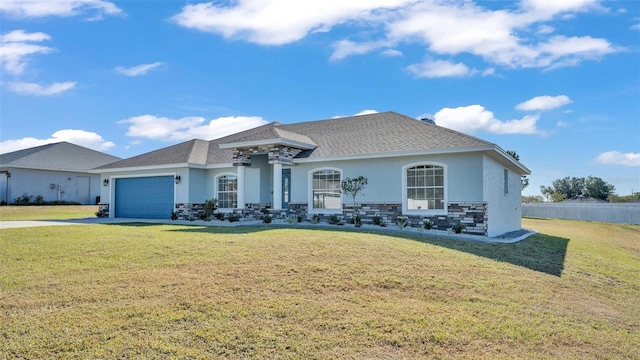 view of front of house featuring a front lawn and a garage