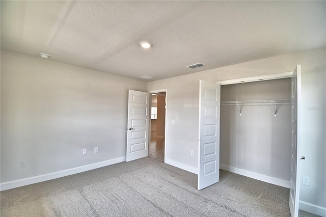 unfurnished bedroom with carpet floors and a closet