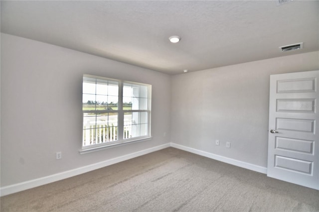 unfurnished room featuring carpet