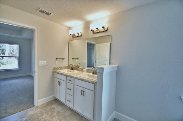 bathroom with vanity and a textured ceiling