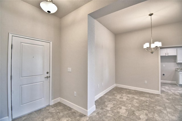 entryway featuring an inviting chandelier