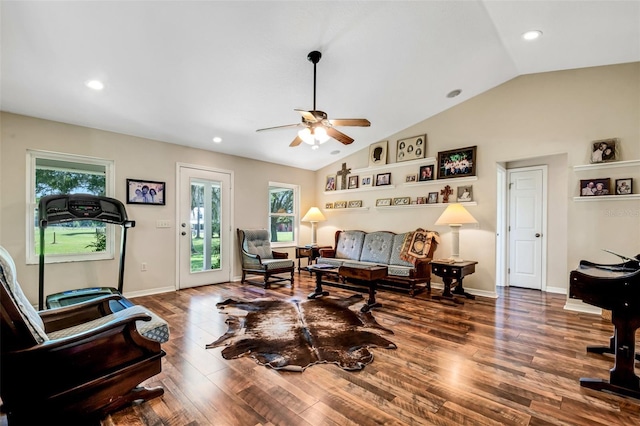 living room with ceiling fan, dark hardwood / wood-style floors, and vaulted ceiling