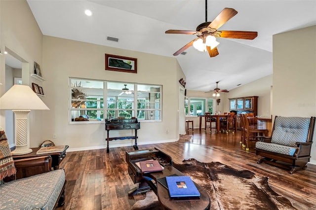 living room with hardwood / wood-style flooring and high vaulted ceiling