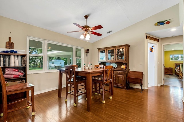 dining space featuring hardwood / wood-style floors, ceiling fan, and vaulted ceiling