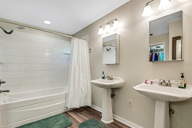 bathroom with sink, shower / bath combo, and hardwood / wood-style flooring