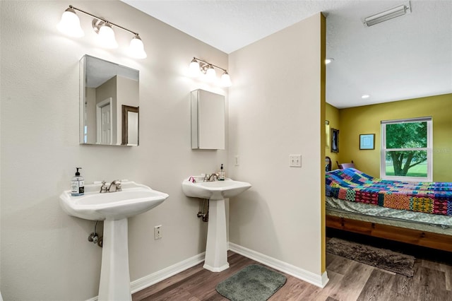 bathroom featuring hardwood / wood-style flooring and double sink